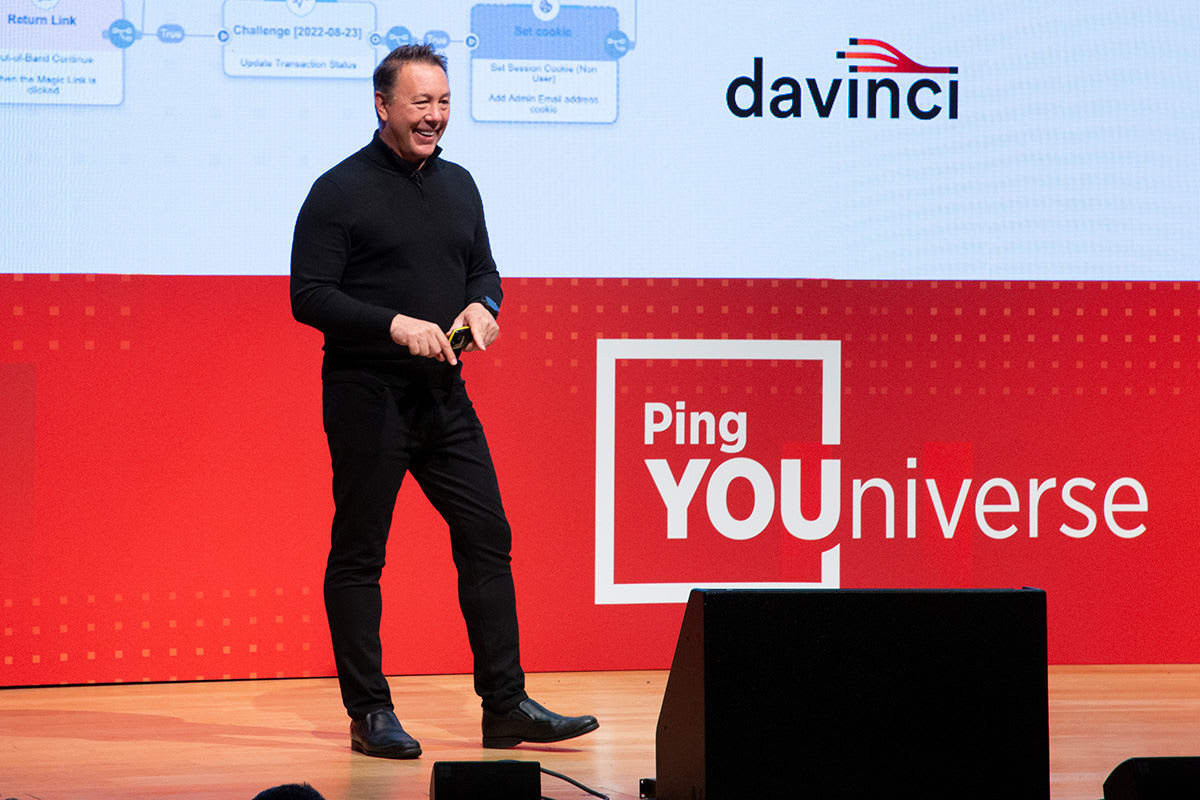 A photo of Andre Durand, Ping Identity CEO, grinning at the crowd from the stage.