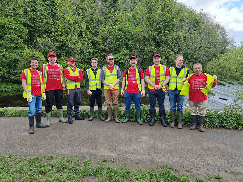 A photograph of Ping employees volunteering with the Water of Leith organization in Edinburgh, UK.