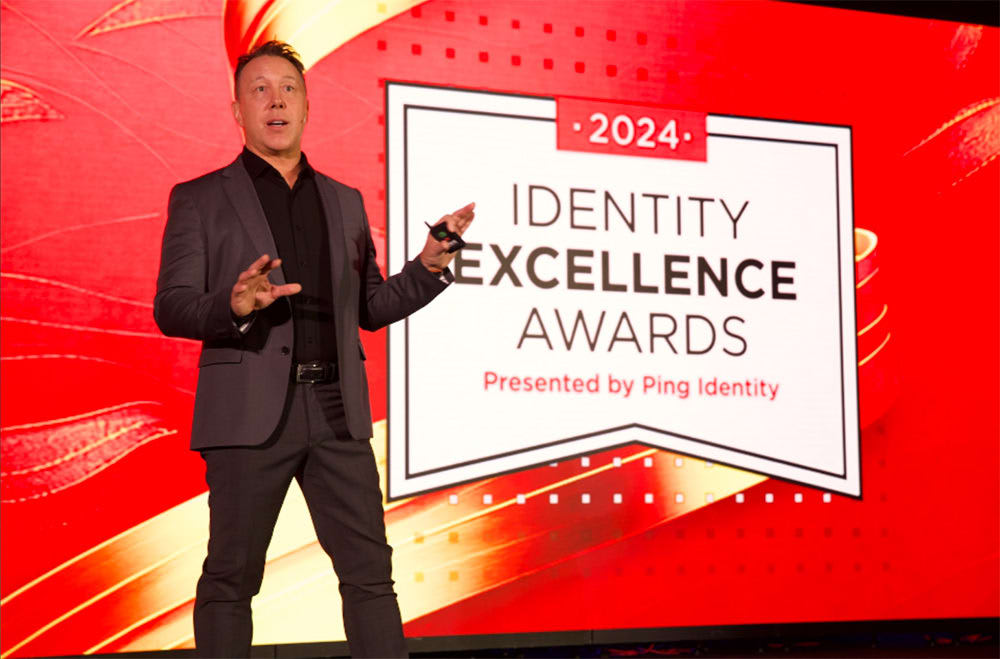 Man presenting at Identity Excellence Awards event