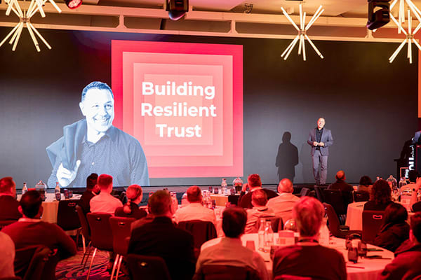 Andre Durand speaking onstage