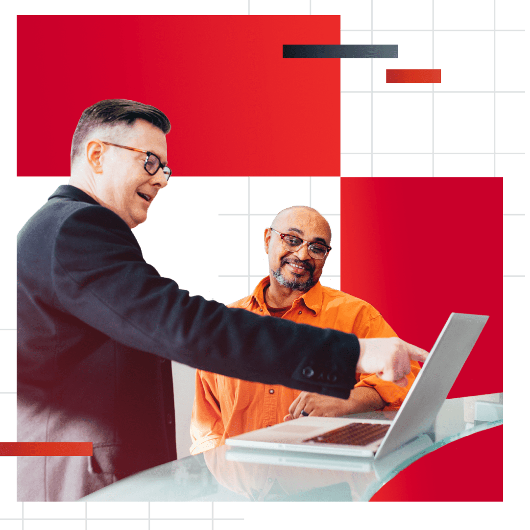 Decorative graphic containing photo of a man smiling while pointing to something on a laptop screen and another man standing next to him smiling as well and looking at whatever the first man is pointing to on the laptop.