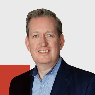 Smiling man blue jacket white shirt professional headshot