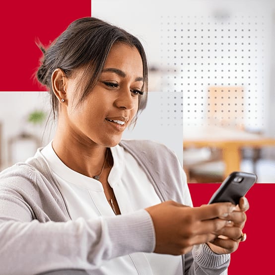 Woman smiling while looking at phone