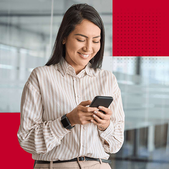 Woman looking down at phone smiling