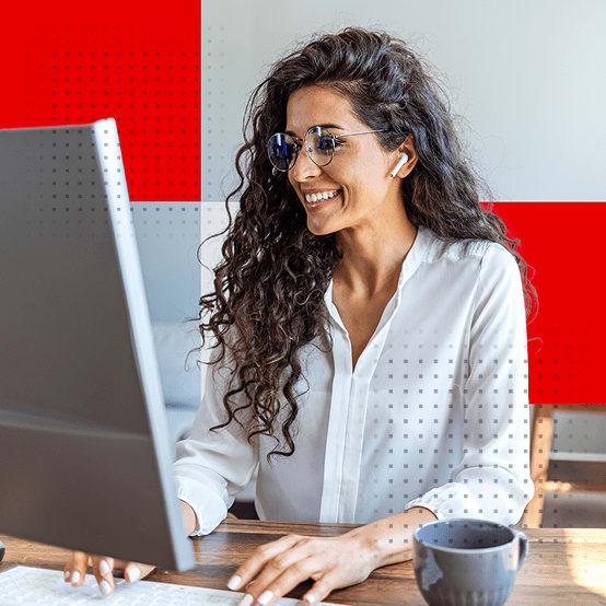 Woman working on computer smiling