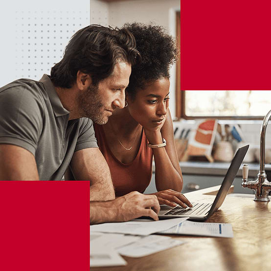 A man and woman working on a laptop together