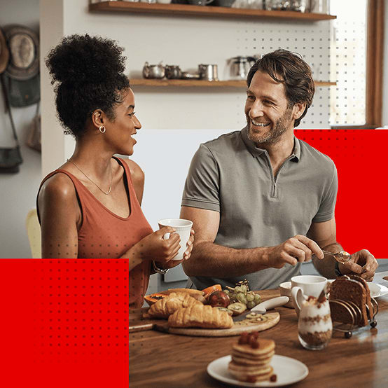 Man and woman eating and talking at dinner table