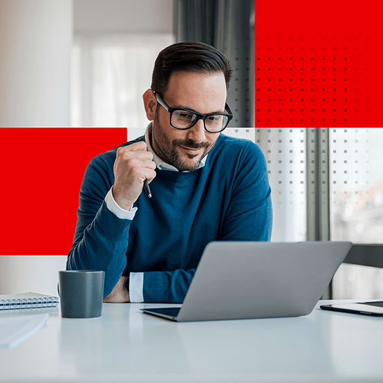 Man sitting at desk working on laptop