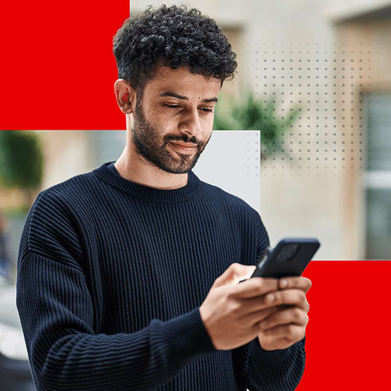 Man standing outside looking at his phone