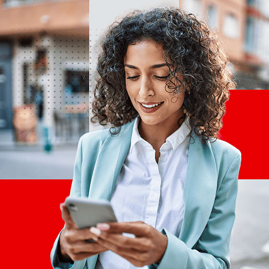 Woman smiling while looking down at her phone