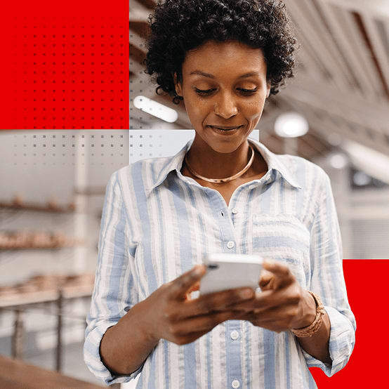 Woman looking down at phone smiling