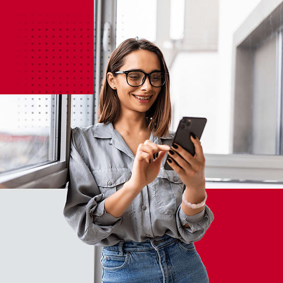 Woman smiling while looking at smartphone