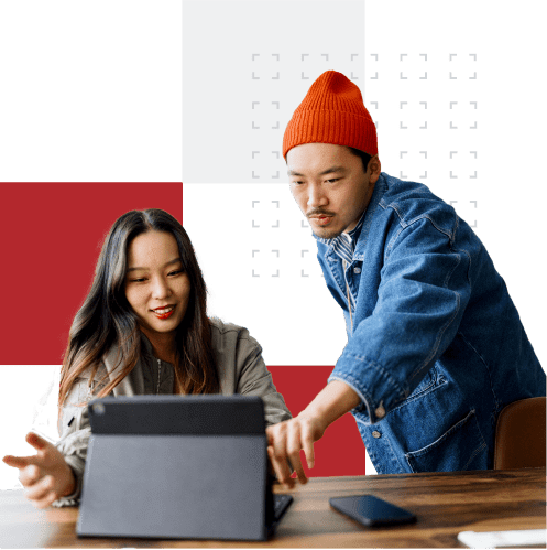 Two people interacting with a digital tablet at a table