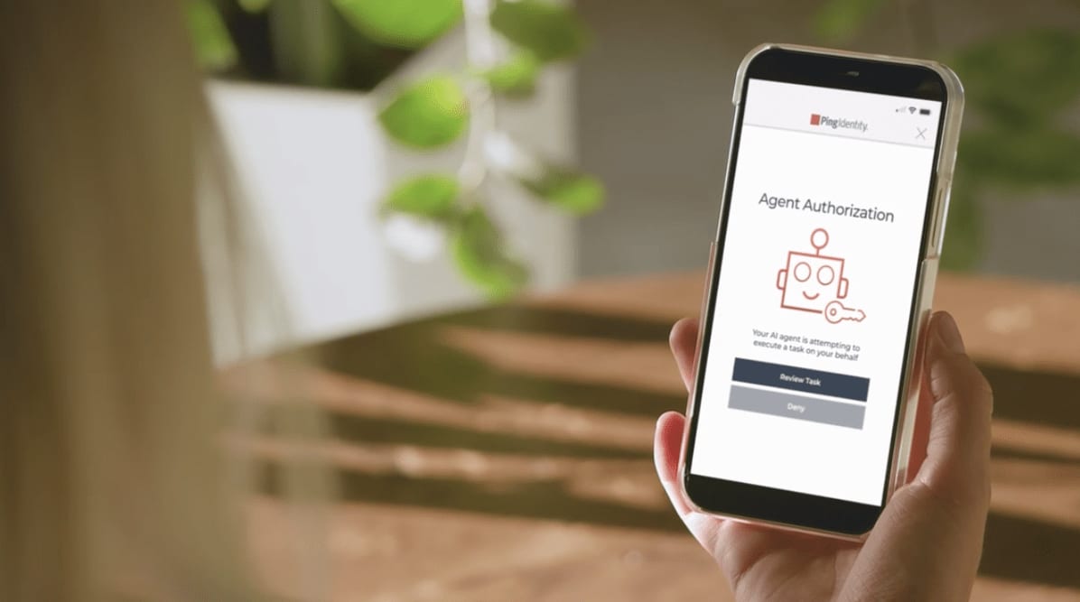 person holding a phone with an agent authorization approval request