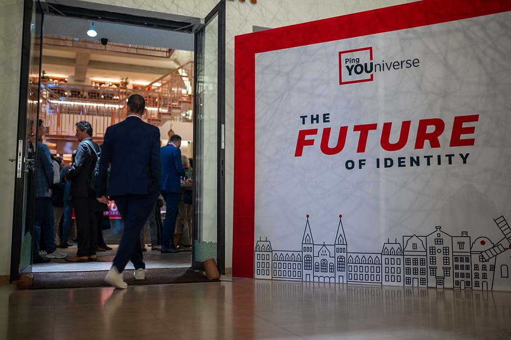 Man entering event banner reads THE FUTURE OF IDENTITY