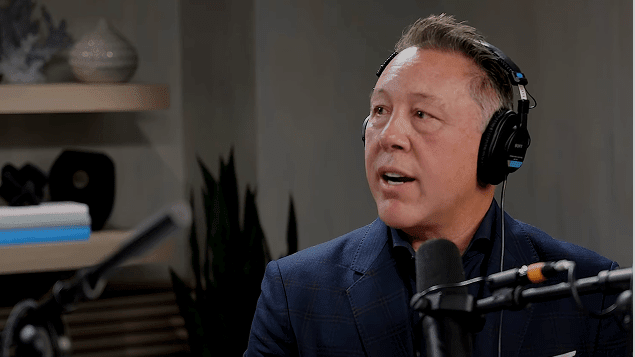 Picture of Ping Identity Founder and CEO Andre Durand with headphones on speaking into a microphone
